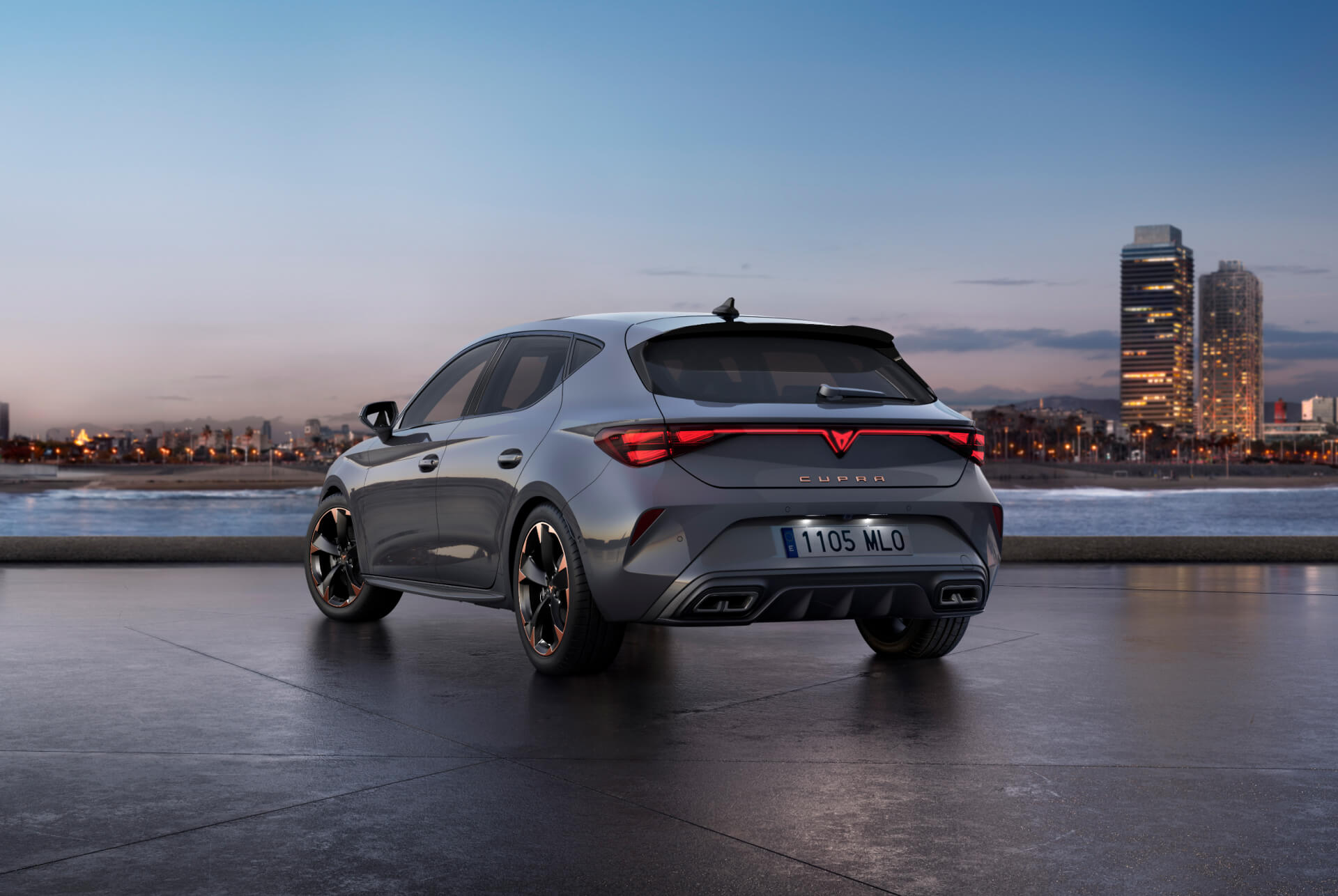 Rear view shot of new cupra leon 2025 glossy grey car model with dynamic chassis control, plus black and copper alloy wheels. City in the background at sunset.