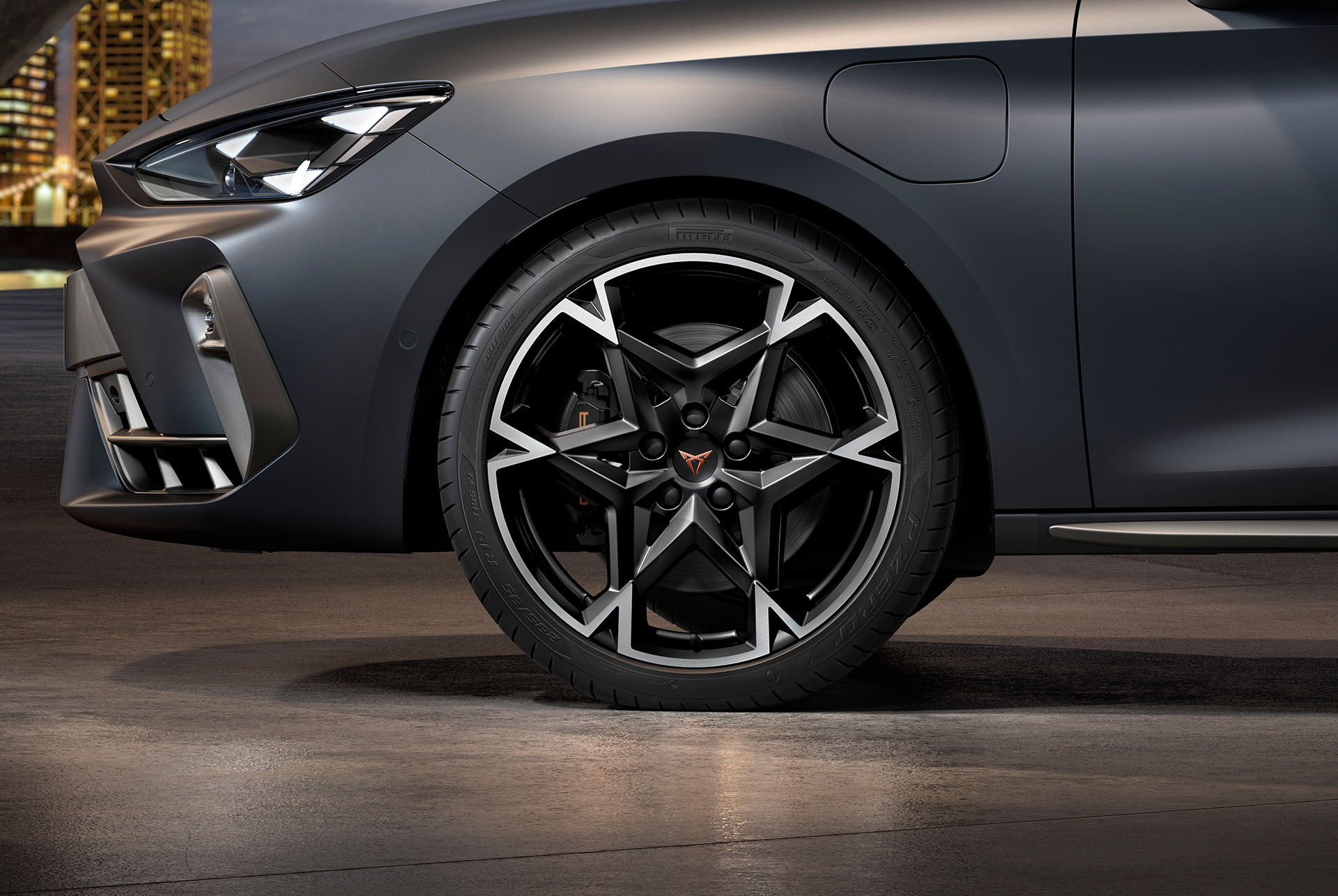 : front side view of left machined polar alloy wheel in black and silver for the new cupra leon 2025, tyres, signature headlights and grey body