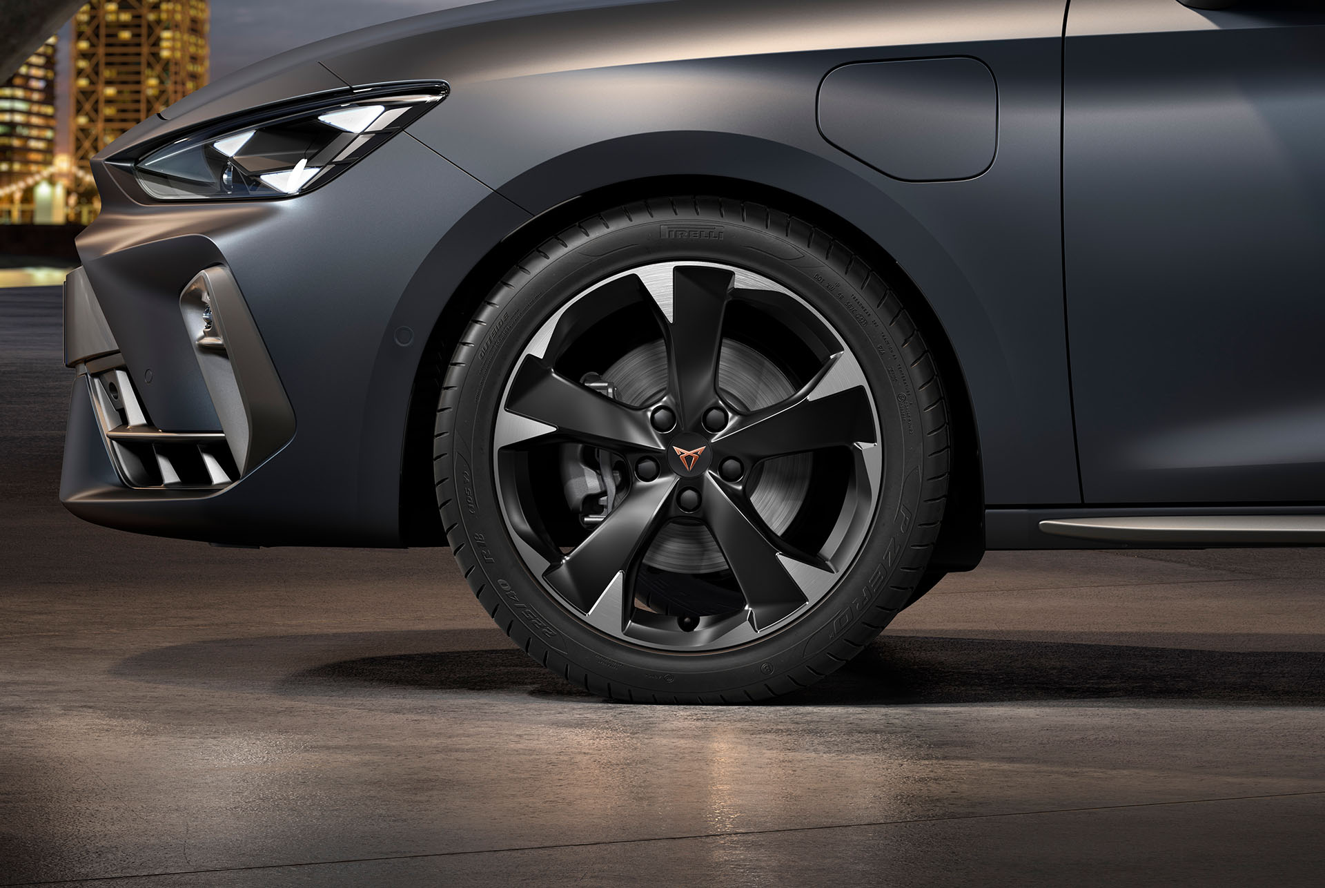 front side view of left machined silver garbi alloy wheel for the new cupra leon sportstourer 2025, tyres, signature headlights and matt grey car body